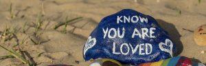 rock with words saying know you are loved, you are dearly loved by God, loved by God, you are loved by God