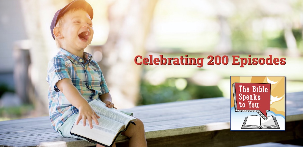 boy laughing with Bible, 