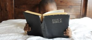 boy reading Bible, making room for God, making room for God in your life