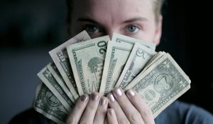 Girl holding money, modern day idols