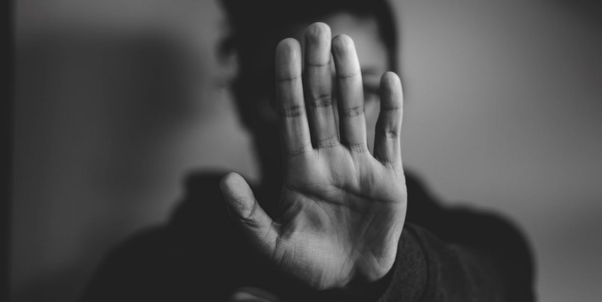 hand held up to say stop, Satan has no power