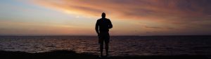 man at beach sunset, need to repent