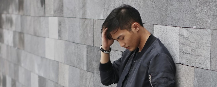 man leaning against a wall thinking, accept God's forgiveness