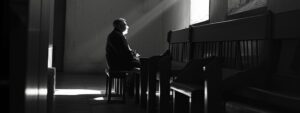 man in church with ray of light, sitting at the feet of Jesus, at the feet of Jesus, the feet of Jesus