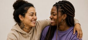 2 women embracing, to love your enemies, love your enemies