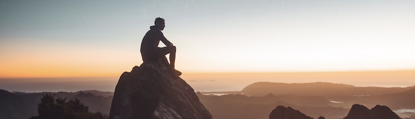 man on rock at sunset, see more healing