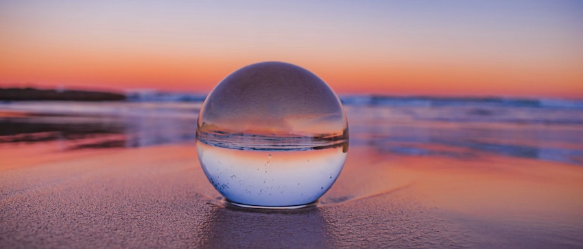 glass ball at sunset on beach, simplicity in Christ